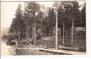 Old postcard showing close up of some cabins at Camp Otter, Pittsburg NH