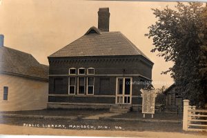 Circa 1918-1919 postcard photograph of the Hancock Public Library with WWI memorial.