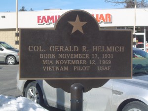 Photograph of Gerald J. Helmich recognition plaque, located in Manchester NH at the corners of -- and -- Streets. Copyright of Martin Miccio for the City of Manchester, and used here with permission.
