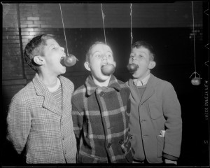 Photograph: "Boys eating apples off strings," Boston Public Library, Leslie Jones Collection [ca 1934-1956].