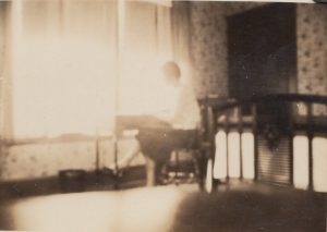 Women writing at a desk in hotel room at Hotel Randall prior to 1937.