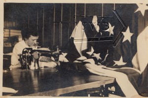 Woman at sewing machine working on American flag, Manchester NH.