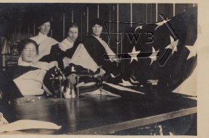 Women posing with flag, mill in Manchester NH.